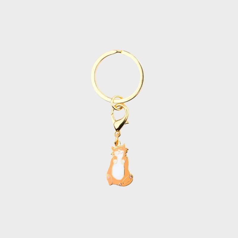 porte-clé en forme de chat roux avec détails dorés